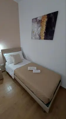 a bed in a room with two towels on it at Loft Pozzillo in Monreale