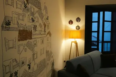 a living room with a drawing on the wall at La Residenza dell' Alloro in Palermo
