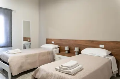 a bedroom with two beds with towels on them at Gennaro Holidays in Corleone