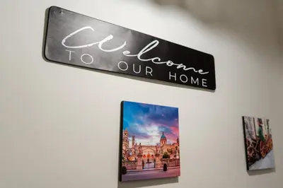 a sign that readselcome to our home hanging on a wall at Gennaro Holidays in Corleone