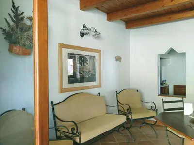 two chairs and a table in a room at Villa Paladino Solunto in Santa Flavia