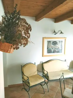 a room with two chairs and a plant on the wall at Villa Paladino Solunto in Santa Flavia