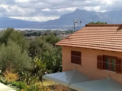 a view of a house with mountains in the background at Villa Paladino Solunto in Santa Flavia