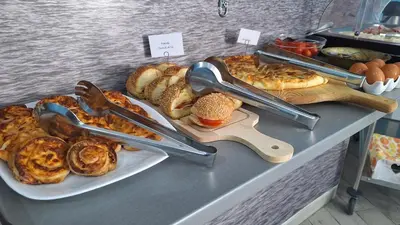 a bakery counter with various types of bread and pastries at B&B A Mare in Castellammare del Golfo