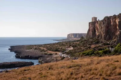 a view of the ocean and a castle on a cliff at Makari Bay Home in San Vito lo Capo