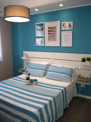 a bedroom with a bed with a blue wall at Makari Bay Home in San Vito lo Capo