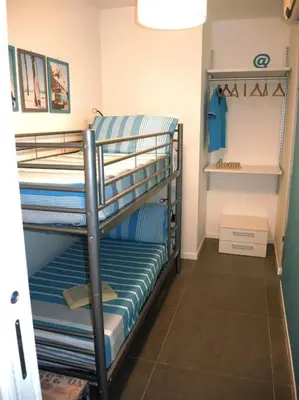 a couple of bunk beds in a room at Makari Bay Home in San Vito lo Capo