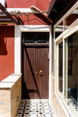 a wooden door of a house with a window at Gennaro Holidays Appartament in Corleone