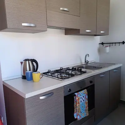 a kitchen with a stove and a sink at Genius Home in Palermo