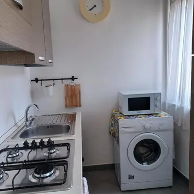 a kitchen with a stove and a washing machine at Genius Home in Palermo