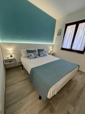 a bedroom with a large bed and two windows at Ca San Vito Lo Capo Villa Maria in San Vito lo Capo