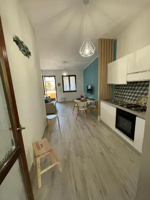 a kitchen and living room with a table and chairs at Ca San Vito Lo Capo Villa Maria in San Vito lo Capo