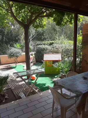 a patio with a table and chairs and a tree at Ca San Vito Lo Capo Villa Maria in San Vito lo Capo
