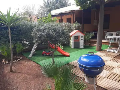 a playground with a slide and a play house at Ca San Vito Lo Capo Villa Maria in San Vito lo Capo