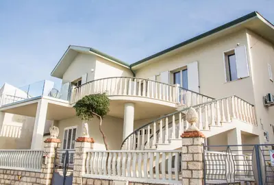 a large white house with a spiral staircase at La Villa di Nonna Pina in Balestrate