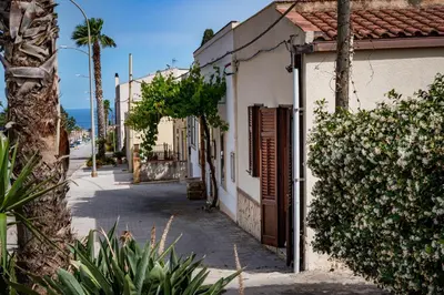 an empty street in a town with a building at La Casetta in San Vito lo Capo