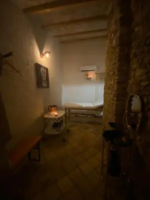 a room with a bench and a table with a mirror at Feudo Del Biviere in Santa Ninfa