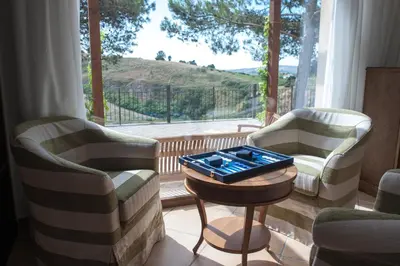 a living room with two chairs and a table with a game at Feudo Del Biviere in Santa Ninfa