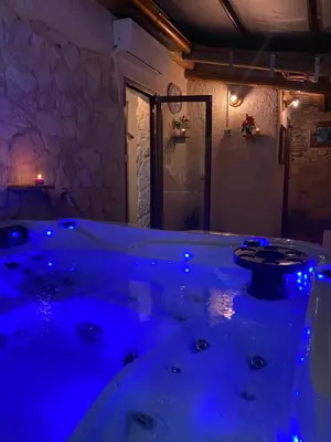a bathroom with a large tub with blue lighting at Feudo Del Biviere in Santa Ninfa