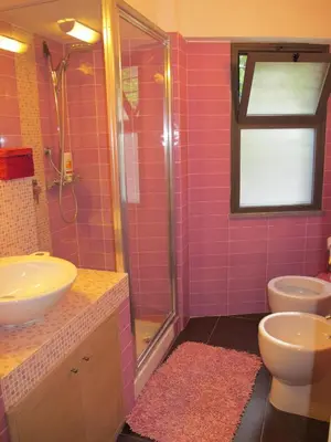 a pink bathroom with a sink and a shower at Villa Le Lanterne Pool & Relax in Mondello