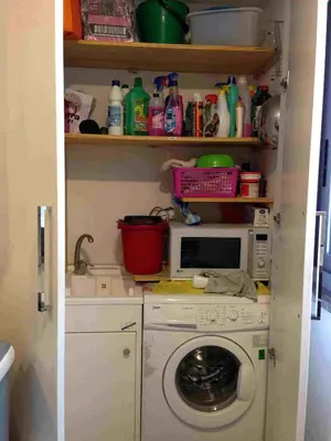 a laundry room with a washing machine and a microwave at Villa Le Lanterne Pool & Relax in Mondello
