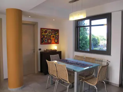 a dining room with a blue table and chairs at Villa Le Lanterne Pool & Relax in Mondello