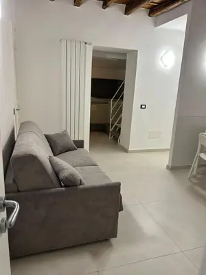 a living room with a couch in the middle of a room at MARGOT HOUSE PALERMO in Palermo