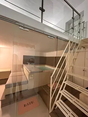 a glass house with a swimming pool and a staircase at MARGOT HOUSE PALERMO in Palermo