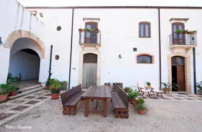 a picnic table in front of a white building at Baglio 