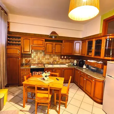 a kitchen with wooden cabinets and a wooden table at Regina Elena in Cinisi
