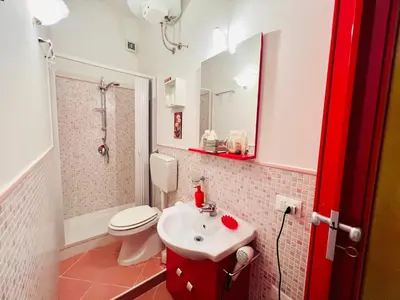 a bathroom with a white toilet and a sink at Regina Elena in Cinisi