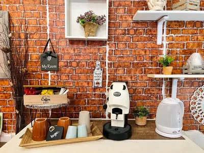 a brick wall with a coffee maker on a counter at Regina Elena in Cinisi