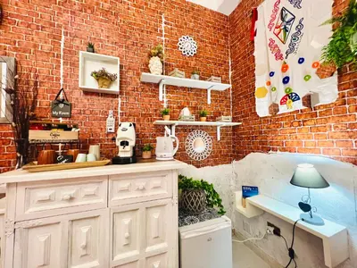 a kitchen with a brick wall and a counter with a lamp at Regina Elena in Cinisi