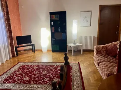 a living room with a couch and a table with a lamp at Sicilian Apartment in Termini Imerese