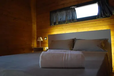 a bedroom with a bed with a window above it at Il Bevaio Di Corleone in Corleone