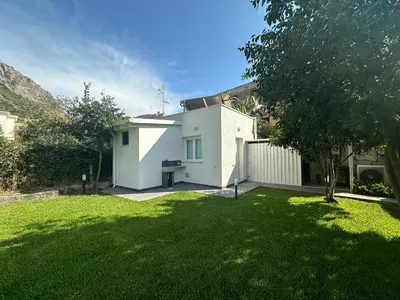 a white house with a fence and a yard at Villa Oasi Verde in Cinisi