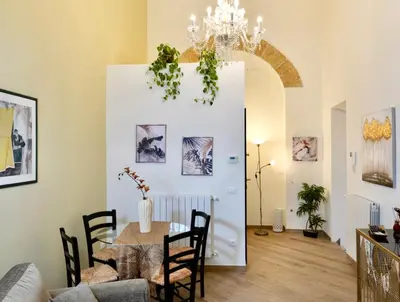 a dining room with a table and a chandelier at TALO' - casa vacanze in Palermo