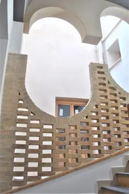 a spiral staircase in a building with a window at TALO' - casa vacanze in Palermo