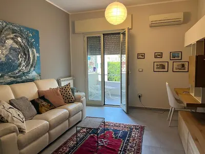 a living room with a couch and a table at Wave house in Palermo