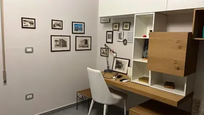 a desk with a chair and a computer in a room at Wave house in Palermo