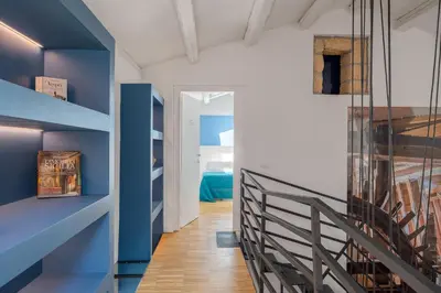 a hallway with blue walls and a blue staircase at Le Stanze di Triyah in Palermo