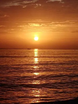 a sunset over the ocean with the sun in the sky at Rocca Mondello Rooms, Beach and Sea in Palermo