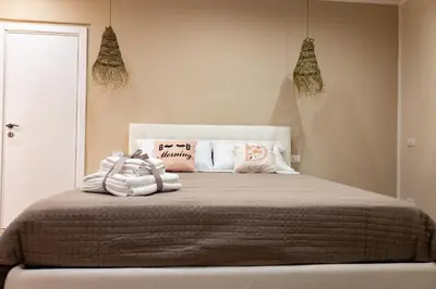 a bedroom with a bed with blankets and pillows at Daria's home apartment rooms in Palermo