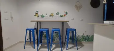 four blue stools under a table in a kitchen at Alloggio Garibaldi in Palermo