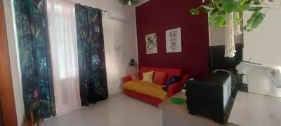 a living room with a red couch and a tv at Alloggio Garibaldi in Palermo