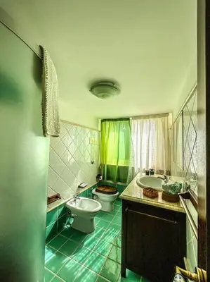 a bathroom with a toilet and a sink and a tub at Casetta della Muri in Isola delle Femmine