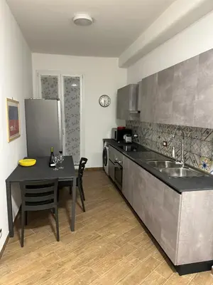 a bathroom with two doors and a toilet in it at SAMMARTINO LUXURY APARTMENT in Palermo