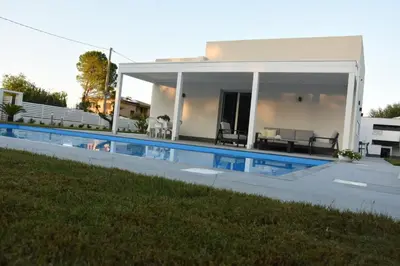 a house with a swimming pool in front of a house at Villa dei Pioppi Deluxe in Carini