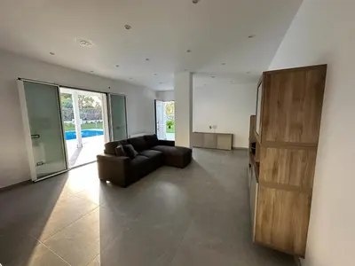 a living room with a couch and a large window at Villa dei Pioppi Deluxe in Carini