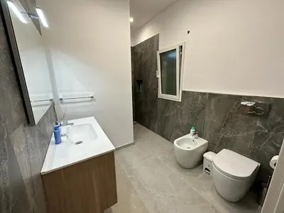 a bathroom with a toilet and a sink and a toilet at Villa dei Pioppi Deluxe in Carini